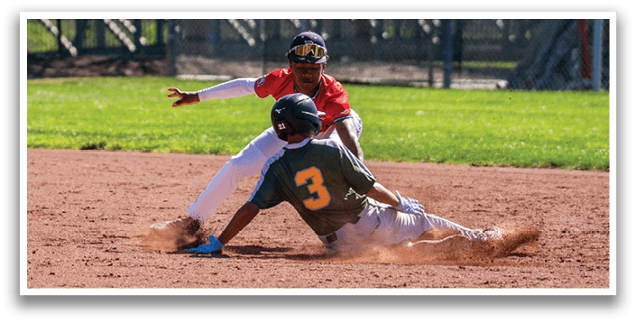 Two baseball players are sliding into a base, one in a green shirt and the other in a red shirt. AI generated content