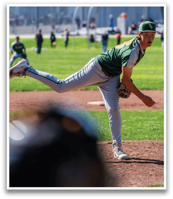 A baseball player in a green and yellow uniform is pitching a ball on a field. AI generated content