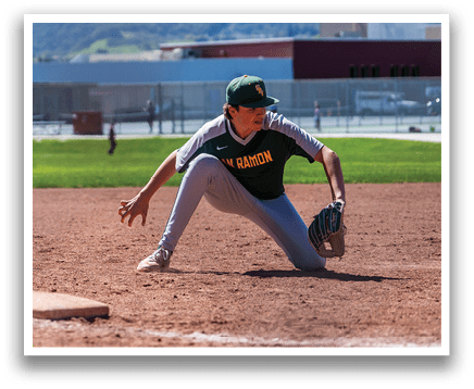 A baseball player in a green and yellow shirt is kneeling on the ground with a baseball glove on his hand. AI generated content