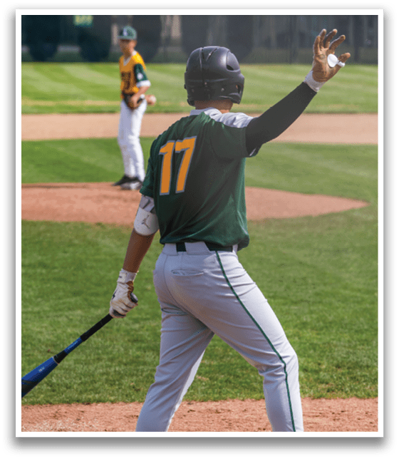 A baseball player wearing a green and yellow jersey is holding a bat and pointing at the sky. AI generated content