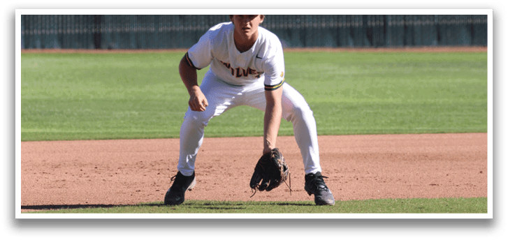 A baseball player is crouching on the field, wearing a white uniform and a baseball glove. AI generated content