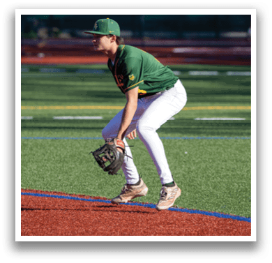A baseball player in a green and yellow uniform is kneeling on the field, holding a catcher's mitt. AI generated content