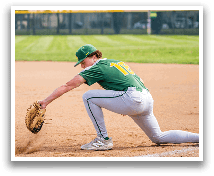 A baseball player in a green and yellow uniform is diving for a ball on a baseball field. AI generated content