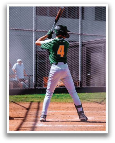 A baseball player in a green and yellow uniform is holding a bat, ready to swing. AI generated content
