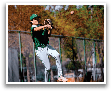 A baseball player in a green shirt and grey pants is about to catch a ball. AI generated content