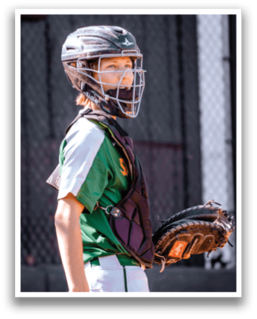A young girl wearing a baseball uniform and a helmet is holding a baseball glove. AI generated content