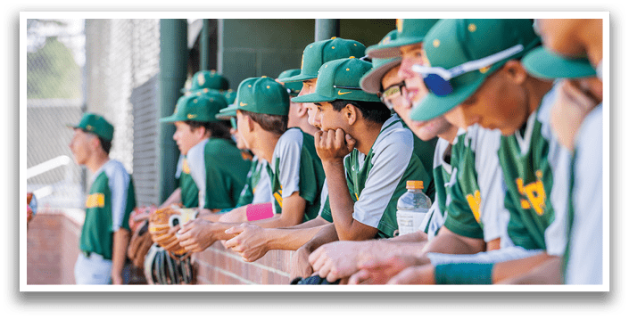 Baseball players in uniforms sitting on a brick wall. AI generated content