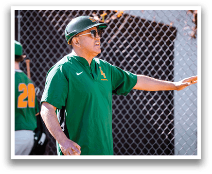 A man wearing a green and yellow shirt is standing on a baseball field, holding a baseball glove. AI generated content