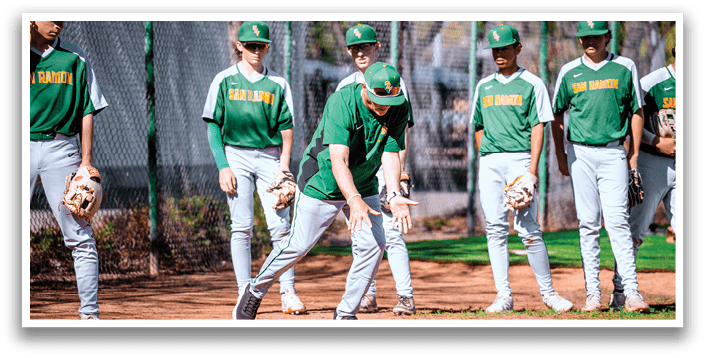 Baseball players in green and white uniforms are standing on a field. One player is bending over and holding a baseball bat. AI generated content