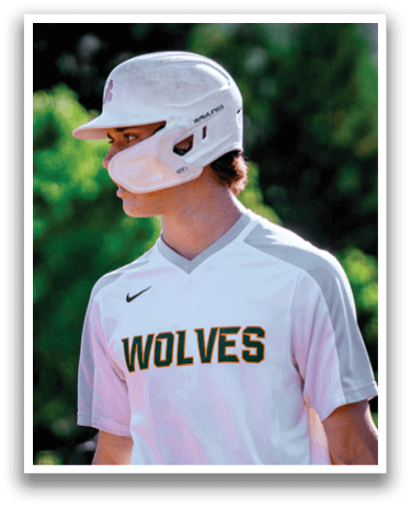A young man wearing a white shirt with the word wolves on it. Description generated by AI