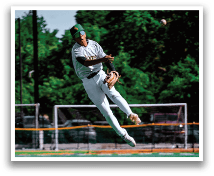 A baseball player in a white uniform is jumping in the air to catch a ball. Description generated by AI