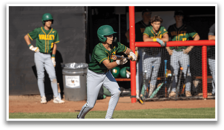 A baseball player in a green and yellow uniform is swinging a bat. Description generated by AI