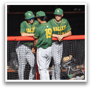 A group of baseball players wearing green and yellow uniforms. Description generated by AI