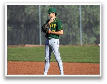A baseball player wearing a green and yellow shirt and holding a baseball glove. Description generated by AI