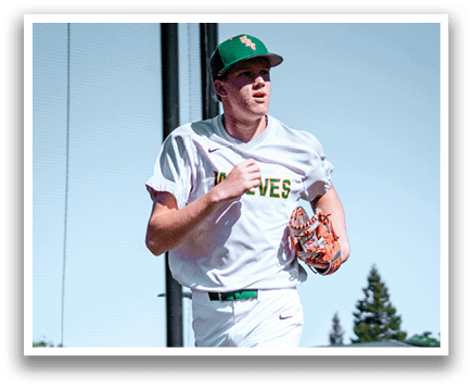 A baseball player wearing a green and white uniform is running on the field. Description generated by AI