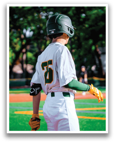 A baseball player wearing a helmet and holding a baseball bat. Description generated by AI
