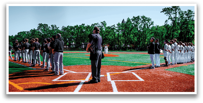 A group of baseball players standing on a field. Description generated by AI