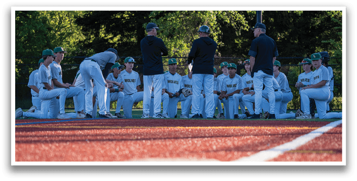 A group of baseball players sitting on the field. Description generated by AI