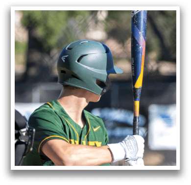 A baseball player is holding a bat and wearing a helmet. Description generated by AI