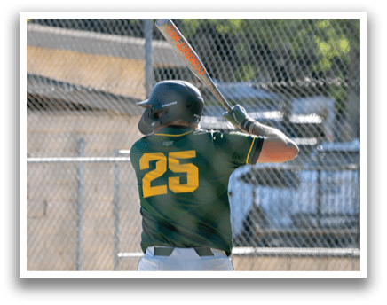 A baseball player in a green and yellow uniform is swinging a bat. Description generated by AI