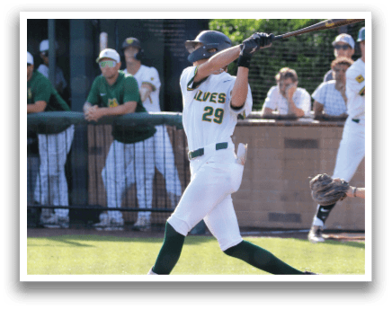 A baseball player in a white uniform with the number 26 on the back is swinging a bat. Description generated by AI