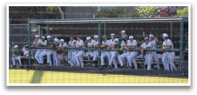 A group of baseball players sitting on a bench. Description generated by AI