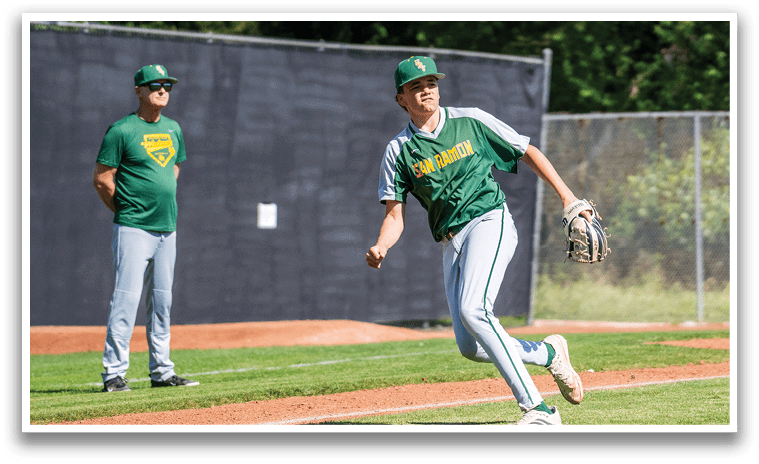 A baseball player in a green and white uniform is running to first base. Description generated by AI