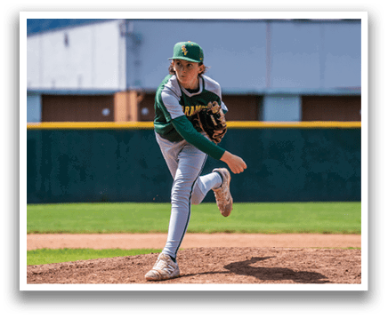 A baseball player in a green and yellow uniform is pitching a ball. Description generated by AI