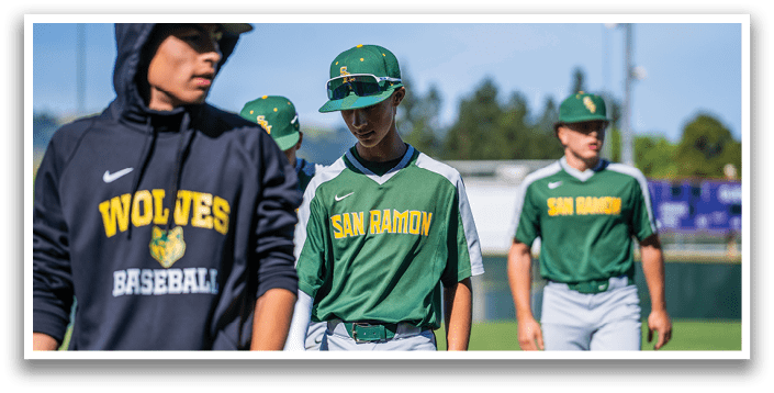 A group of baseball players wearing green and white uniforms. Description generated by AI