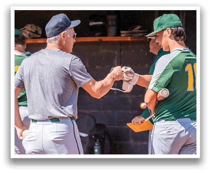 A man wearing a green shirt shakes hands with another man. Description generated by AI