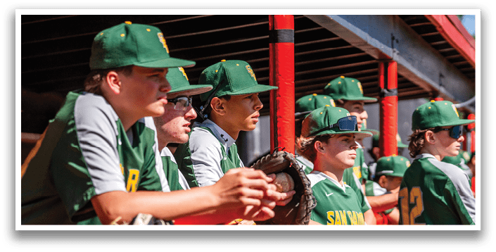 A group of baseball players wearing green and yellow uniforms. Description generated by AI