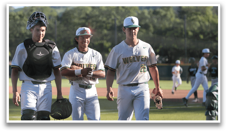 Three baseball players walking on the field. Description generated by AI