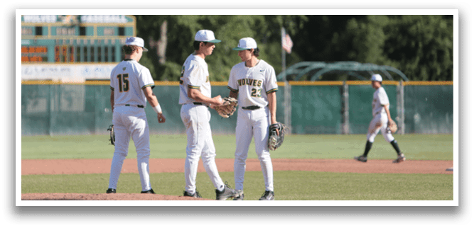 A group of baseball players standing on a field. Description generated by AI