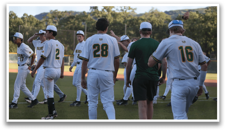 A group of baseball players wearing white uniforms. Description generated by AI