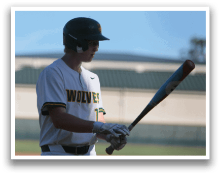 A baseball player holding a bat. Description generated by AI