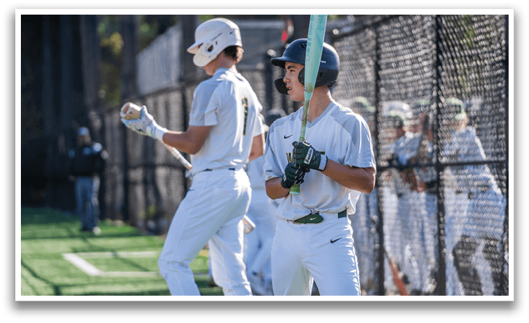 A baseball player holding a bat. Description generated by AI