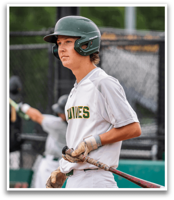 A young man holding a baseball bat. Description generated by AI