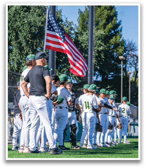 A group of baseball players standing on a field. Description generated by AI