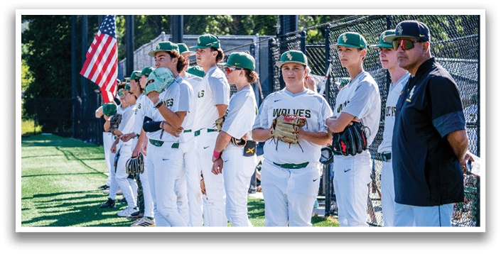 Baseball players standing in a line on a field. Description generated by AI