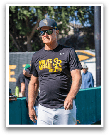 A man wearing a black shirt with the word wolves on it. Description generated by AI