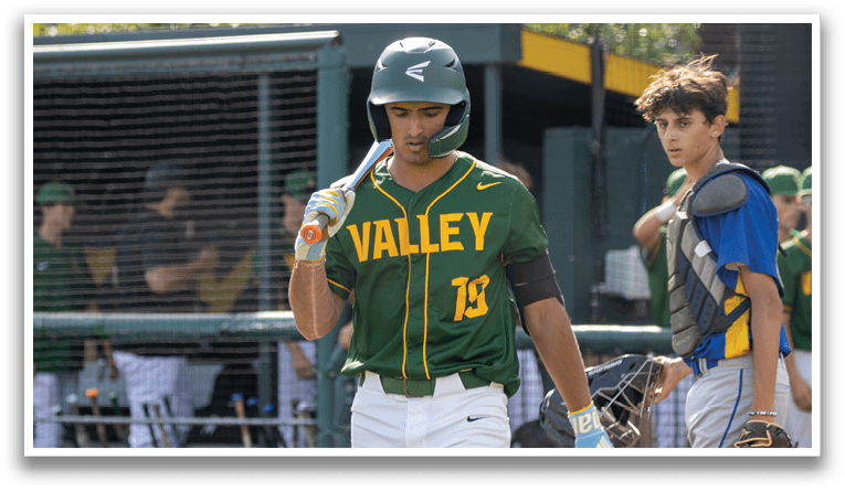 A baseball player wearing a green and yellow jersey holding a bat. Description generated by AI