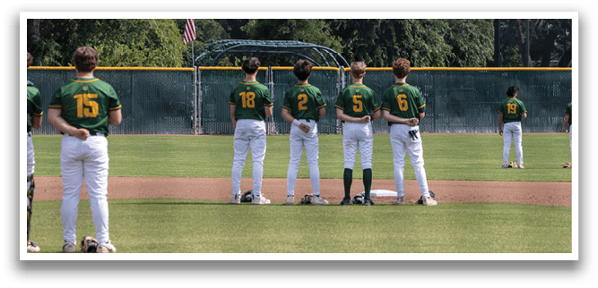 A group of baseball players standing on a field. Description generated by AI