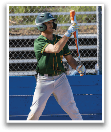 A baseball player in a green and yellow uniform holding a bat. Description generated by AI