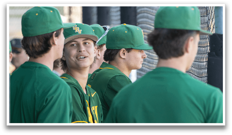 A group of young men wearing green hats and shirts. Description generated by AI