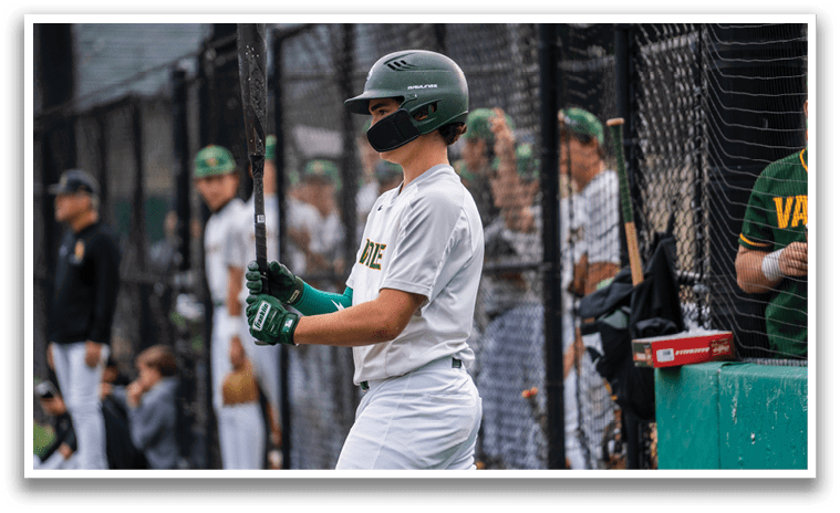 A baseball player holding a bat. Description generated by AI
