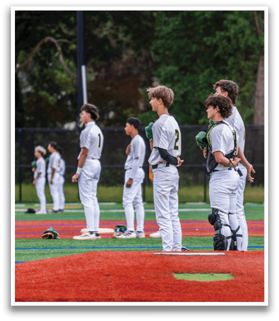 A group of baseball players standing on a field. Description generated by AI