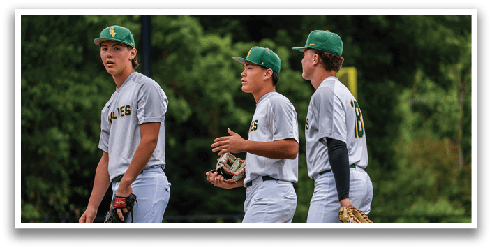Three baseball players wearing white uniforms. Description generated by AI