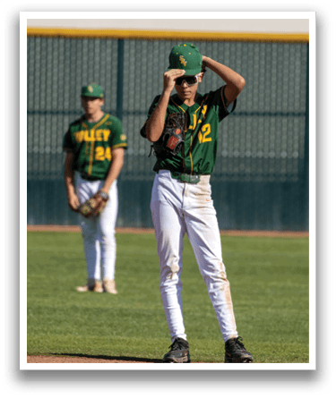 A baseball player wearing a green and yellow shirt and white pants. Description generated by AI