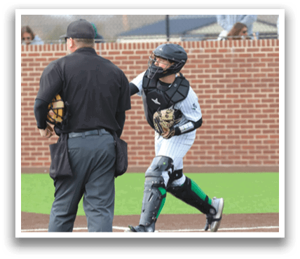 A baseball player wearing a helmet and catcher's gear is running towards home plate. Contenido generado con IA