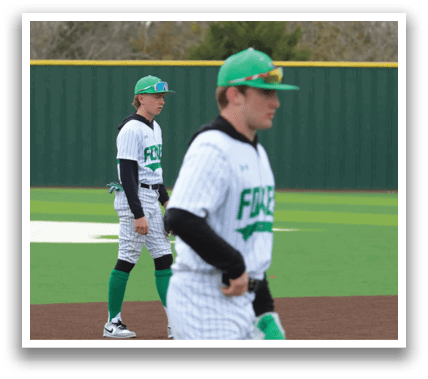 Two baseball players in uniforms are standing on a field. Contenido generado con IA